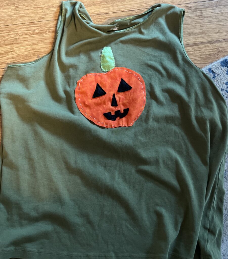 Dark green tank top with appliquéd Jack-o-latern hand sewn on top.